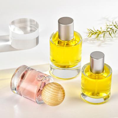 China Perfume Glass Bottle 30ml 50ml Bayonet Cylinder Transparent Perfume Subpackage Cosmetics Spray Bottle With Wooden Cover for sale