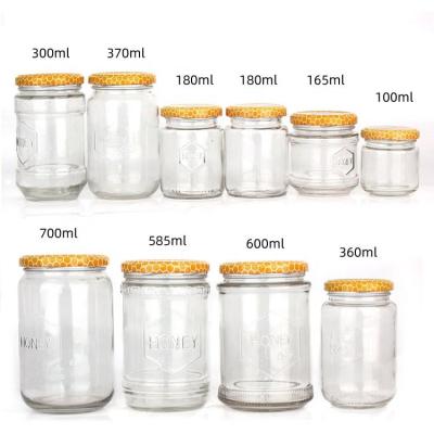 China 100ml 300ml 700ml Clear Honey Jam Food Glass Jar Bottles With Metal Lid for sale