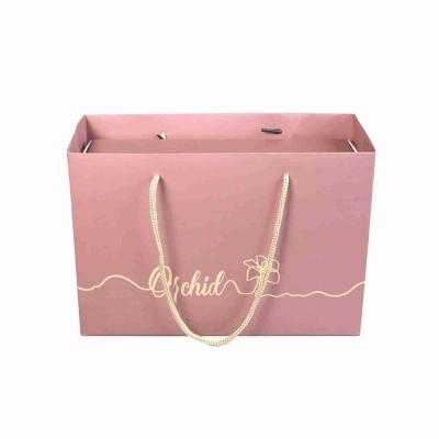 China Matte Laminated Pink Shopping Printed Paper Gift Bags Custom Logo With Ribbon Handle for sale