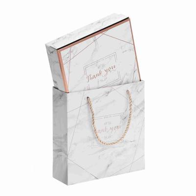 China Kuaima Rose Gold Boutique Embossed Printed Paper Gift Bags Marble Paper Boxes Custom for sale