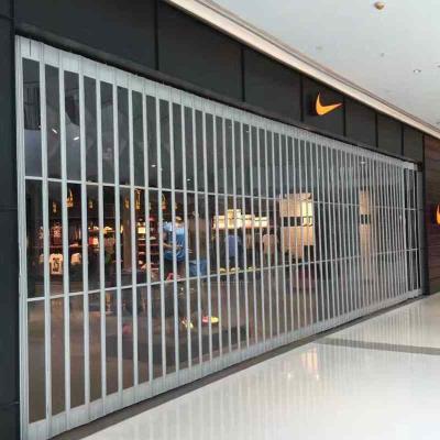 China Puertas de seguridad plegables laterales de policarbonato de transparencia para grandes almacenes en venta