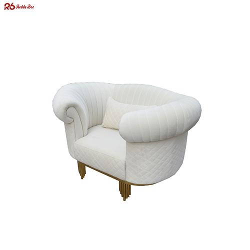 Close-up view of sofa's velvet fabric and gold-plated legs