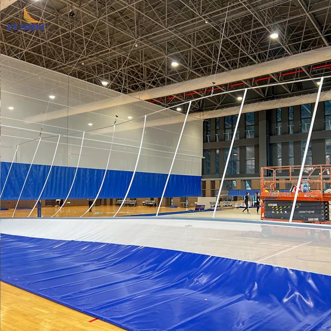 Sports divider curtain installation in large hall