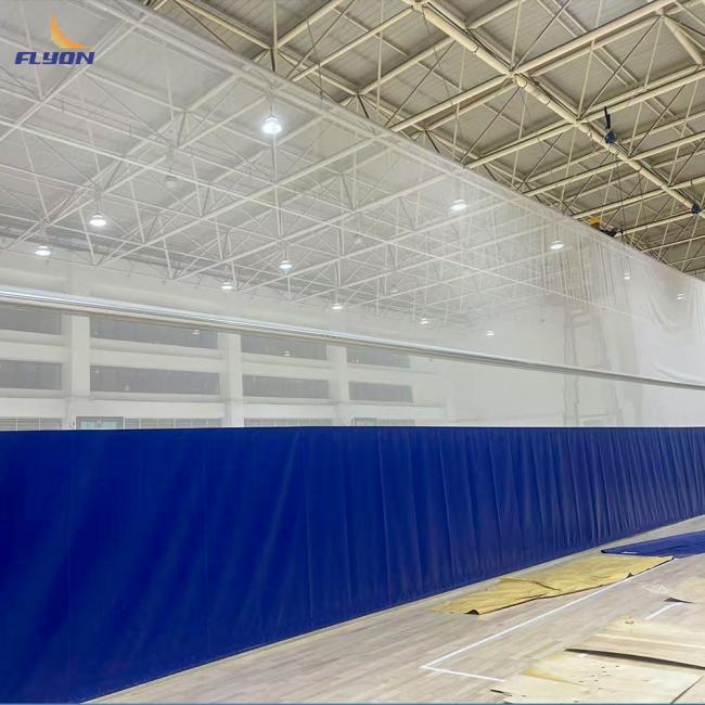 Sports facility with multiple divider curtains deployed