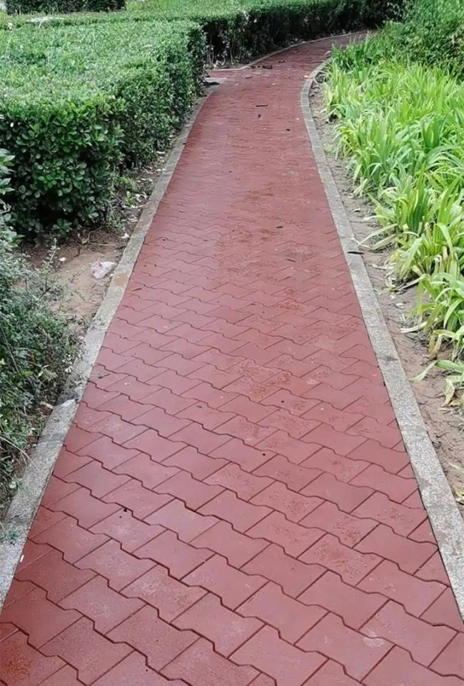 Grey rubber flooring tiles installed in playground setting