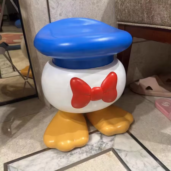 Smiling cartoon character resin stool - side view