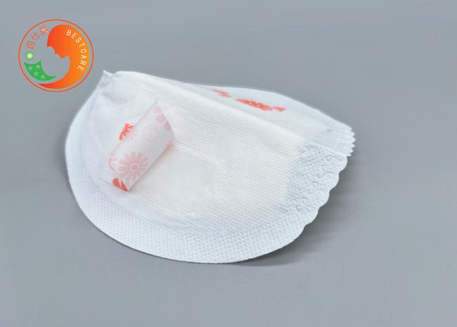 Breast milk pad demonstrating secure adhesive placement