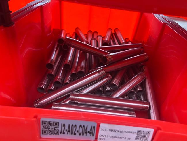 Multiple stainless steel barrel nipples on display
