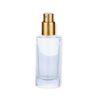 China Unique 50ml Glass Cosmetic Packaging Cylinder Perfume Bottle With Gold Spray Head for sale