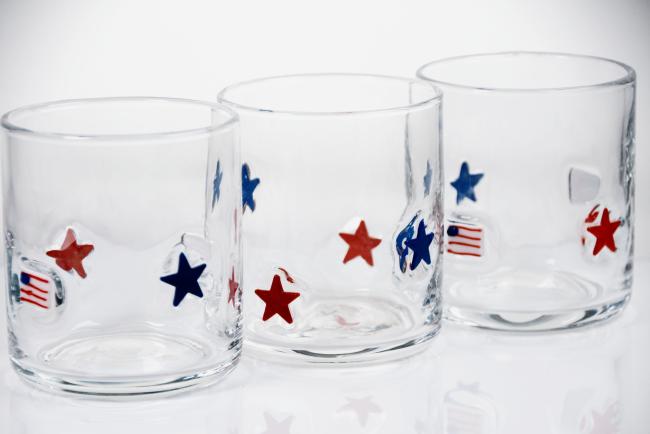 Hand blown patriotic whiskey glass showcasing red and blue stars design