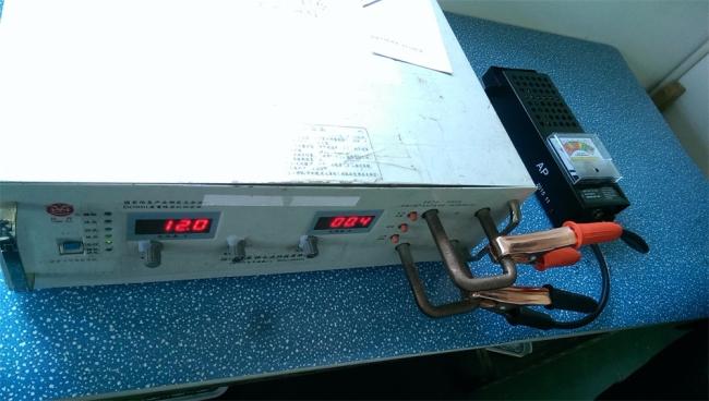 Professional battery tester in use with vehicle battery connections