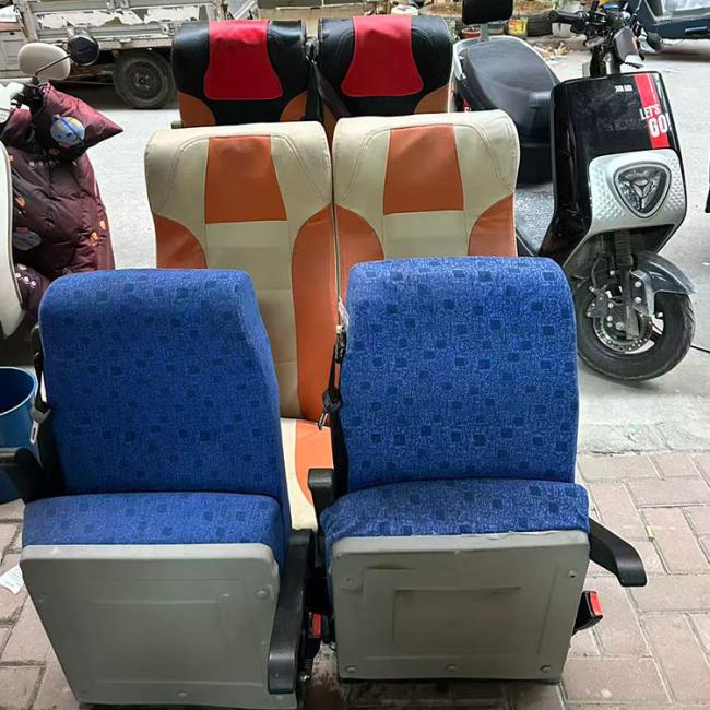 Close-up view of bus passenger seat construction and adjustment mechanisms