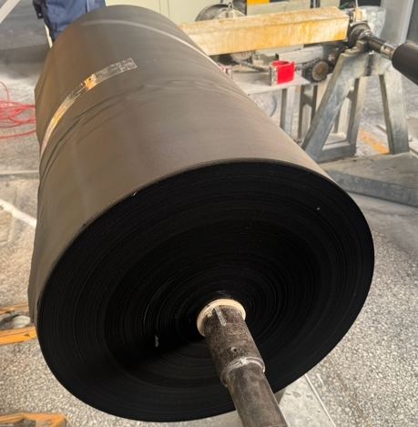 Black-dyed fiberglass fabric sample showing texture and deep black color