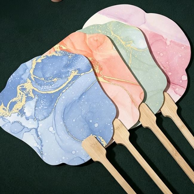 Showcase collection of diverse blue, pink, green, and orange marbled paint art paper hand fans