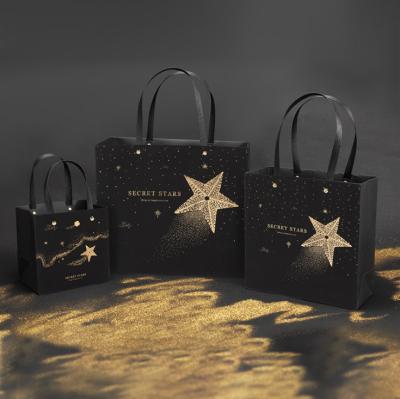 China Black Stamping Star Shopping Bag Customized Logo Printed Tote Paper Gift Bags for sale