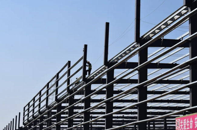 Steel structure warehouse with corrugated steel sheet wall cladding and rolling door