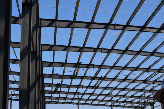 Interior of steel structure building showing roof ventilation and transparent roof sheets