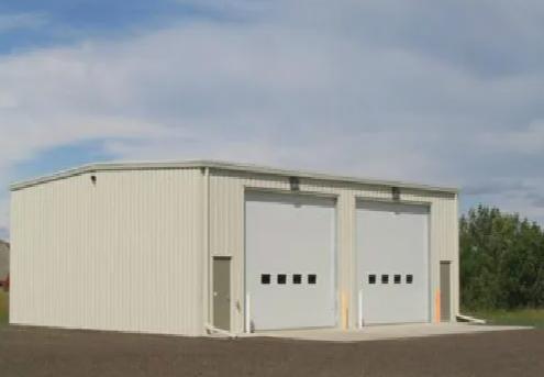Prefabricated steel building interior with H-section steel columns and roof purlins