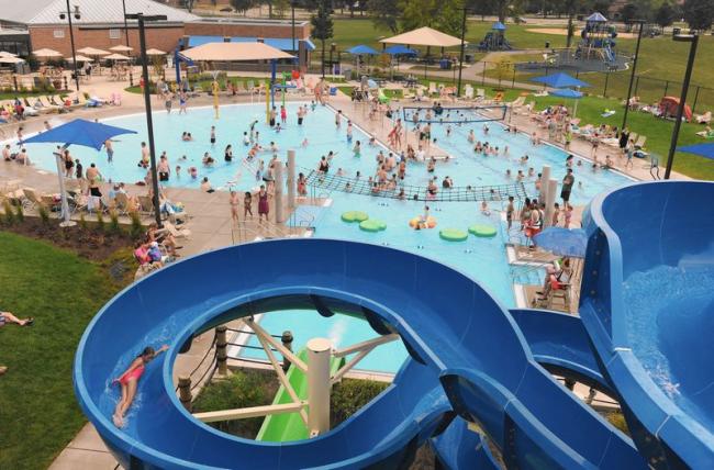 Children enjoying water slide in outdoor park setting