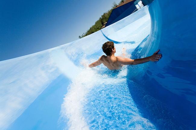 Complete water slide system with landing pool and water features