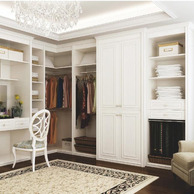 Custom L-shaped walk-in closet showing shaker style doors and interior organization