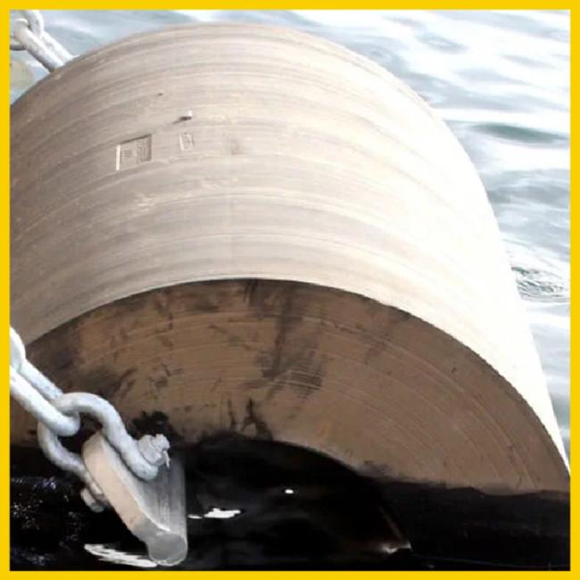 Close-up view of cylindrical marine fender in operation