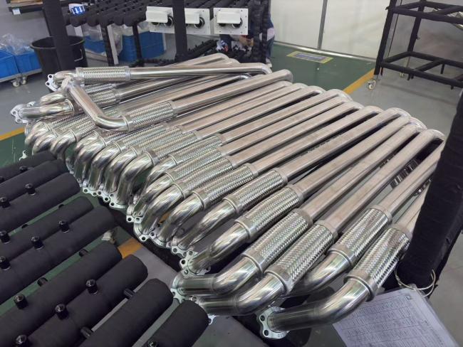 Stainless steel piping system components and manufacturing process