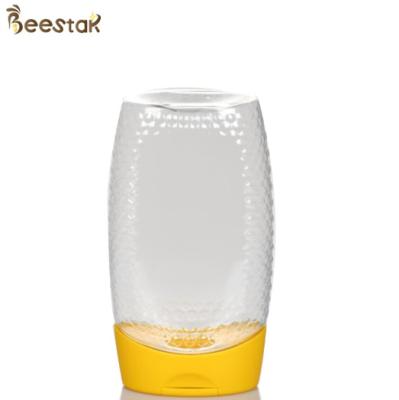 China High Quality Transparent 365ml Plastic Honey Bottles Bulk Yellow Lid for honey storage for sale