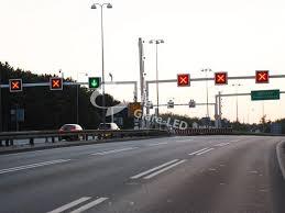 LED lane control sign displaying red cross and green arrow traffic signals