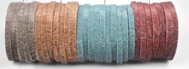 Non-woven sanding belt being used on metal surface