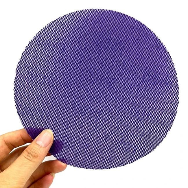 Mesh sandpaper in use on drywall surface