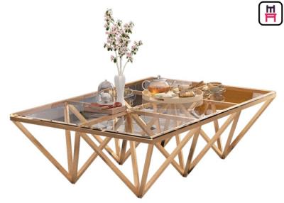 China Indoor Tempered Glass Top Stainless Steel Coffee Table With Triangle Geometrical Base for sale