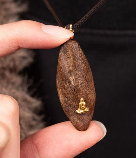 Carved Agarwood Buddha Necklace Pendant front view showcasing detailed craftsmanship
