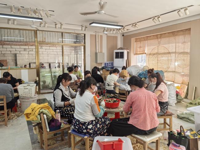 Agarwood artisan performing detailed carving work