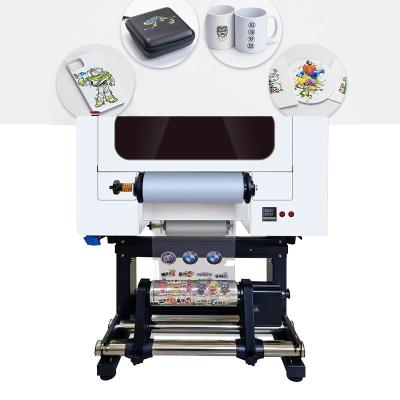 China Impressora de etiquetas de cristal DTF UV de 30 cm 2 em 1 máquina com cabeça dupla XP600 à venda
