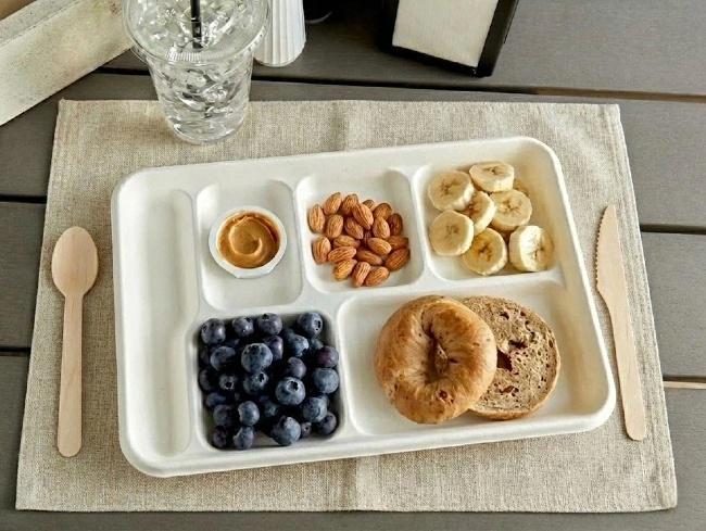 6-compartment disposable bagasse food trays for institutional catering and school lunches.