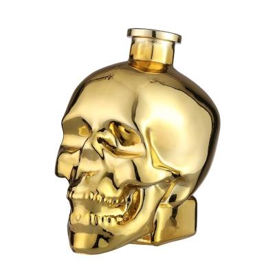 China Rubber Stopper Skull Shape Glass Bottles Golden Electroplate Luxury Wine Customized Logo for sale