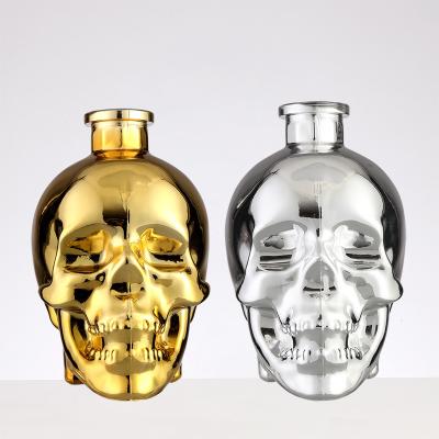 China Cap with Brush Seal Transparent Gold and Silver Skull Glass Whisky Vodka Wine Bottle for sale