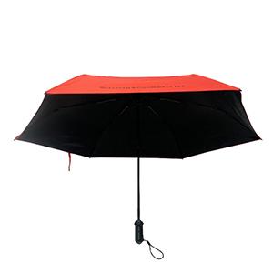 Red Self opening travel umbrella demonstrating compact folded size and automatic mechanism