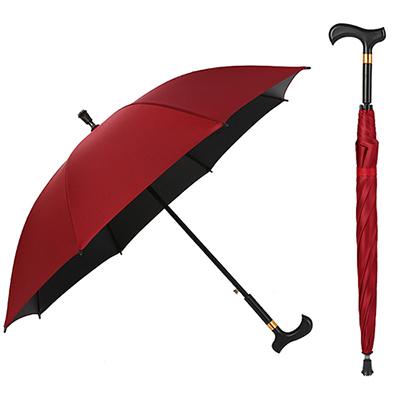 Red elderly man's cane umbrella providing walking support and rain protection