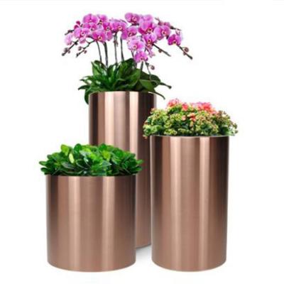 China Sus 304 Mirror Round Metal Flower Pots Metal Flower Planter For Park Mall for sale