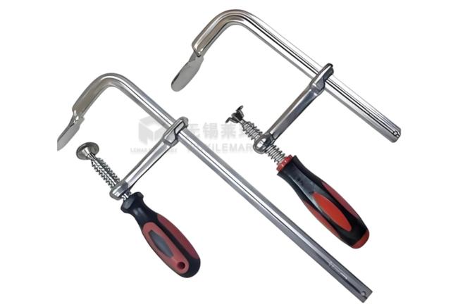Oversized Jaw Ratchet Insert F Clamp in use on welding table with large workpiece