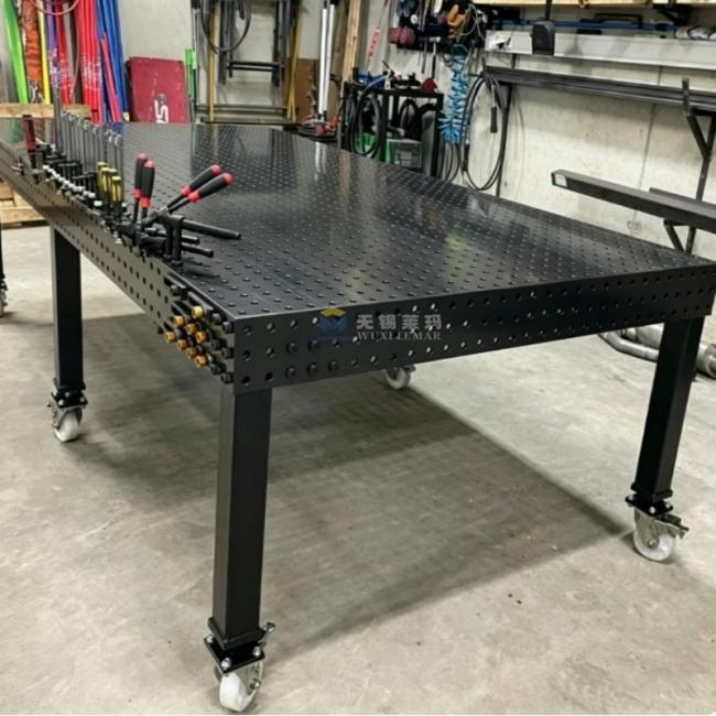D28 welding table in use with heavy equipment frame