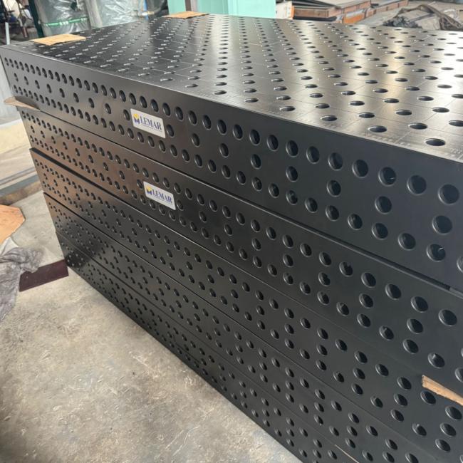 Close-up view of D28 welding table precision holes and construction