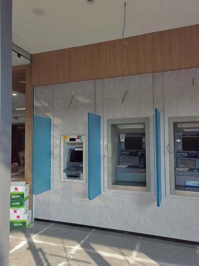 Modern bank self-service area design using lightweight marble texture ACP panels as a cost-effective alternative to real stone for ATM machine renovation.