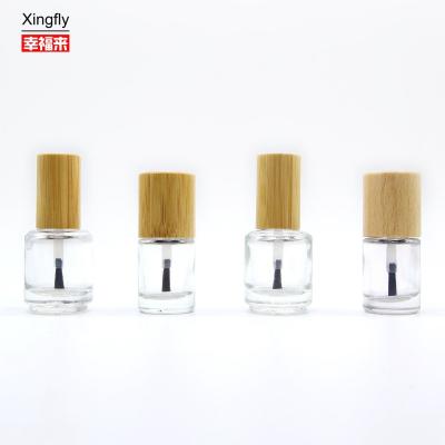 China Botella redonda de esmalte de uñas de 11 ml con tapa de madera Gel UV vacío Botella de pegamento de esmalte de uñas en venta