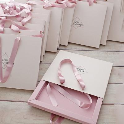 China Customized Ribbon Handle Boutique Jewellery Gift Gold Foil Logo Shopping Paper Bags For Hair Extension for sale