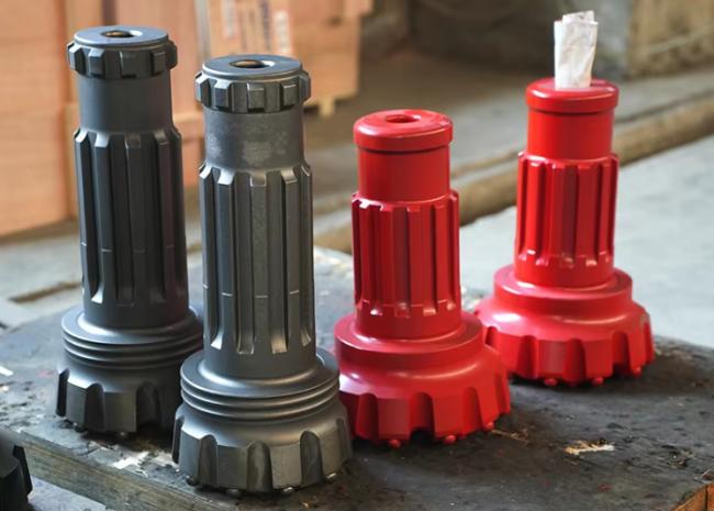 Water well impact drill bit close-up showing spherical tooth design