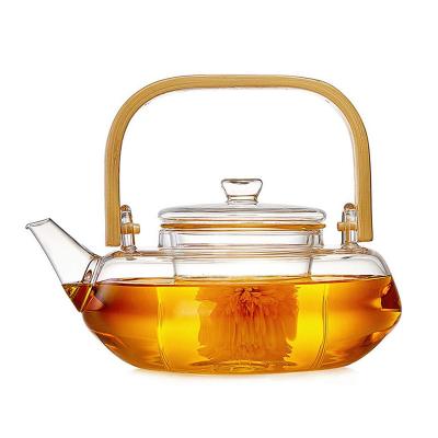China Pote floreciente transparente del té con el filtro, taza de té soplada mano fijada con la caldera en venta