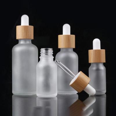 China Custom Glass Cosmetic Serum Bottle 30ml 1oz Frosted Round Shoulder Dropper Bottle For Essential Oils for sale